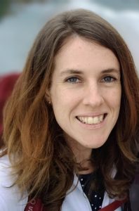 Woman with long brown hair smiling