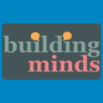 Building Minds logo, featuring the word “building” in muted blue-green lettering above “minds” in pink, with two small orange circular accents, on a dark teal background.