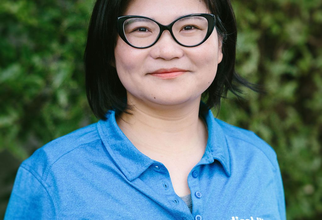 Yoky Yao, chinese woman, black hair wearing glasses and blue polo shirt