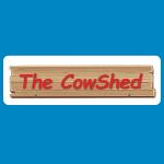 The Cow Shed logo with red script text reading “The CowShed” on a wooden plank sign.