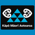 Kāpō Māori Aotearoa logo, featuring a turquoise geometric triangle made from smaller triangles, flanked by two white koru designs, with the organisation’s name in white on a black background.