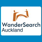 WanderSearch Auckland logo, featuring two abstract orange figures connected by a sweeping curved shape above the organisation’s name in dark blue, on a white background.