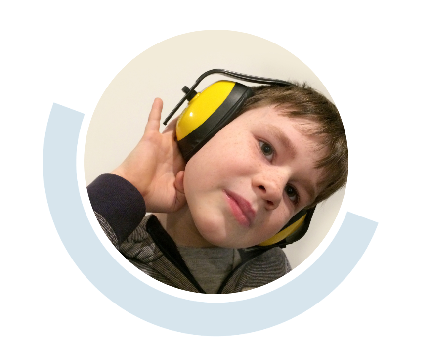 Website header graphic with a pale background and curved light blue accents, featuring a circular close-up of a young child wearing large yellow-and-black ear defenders and resting their head to one side.